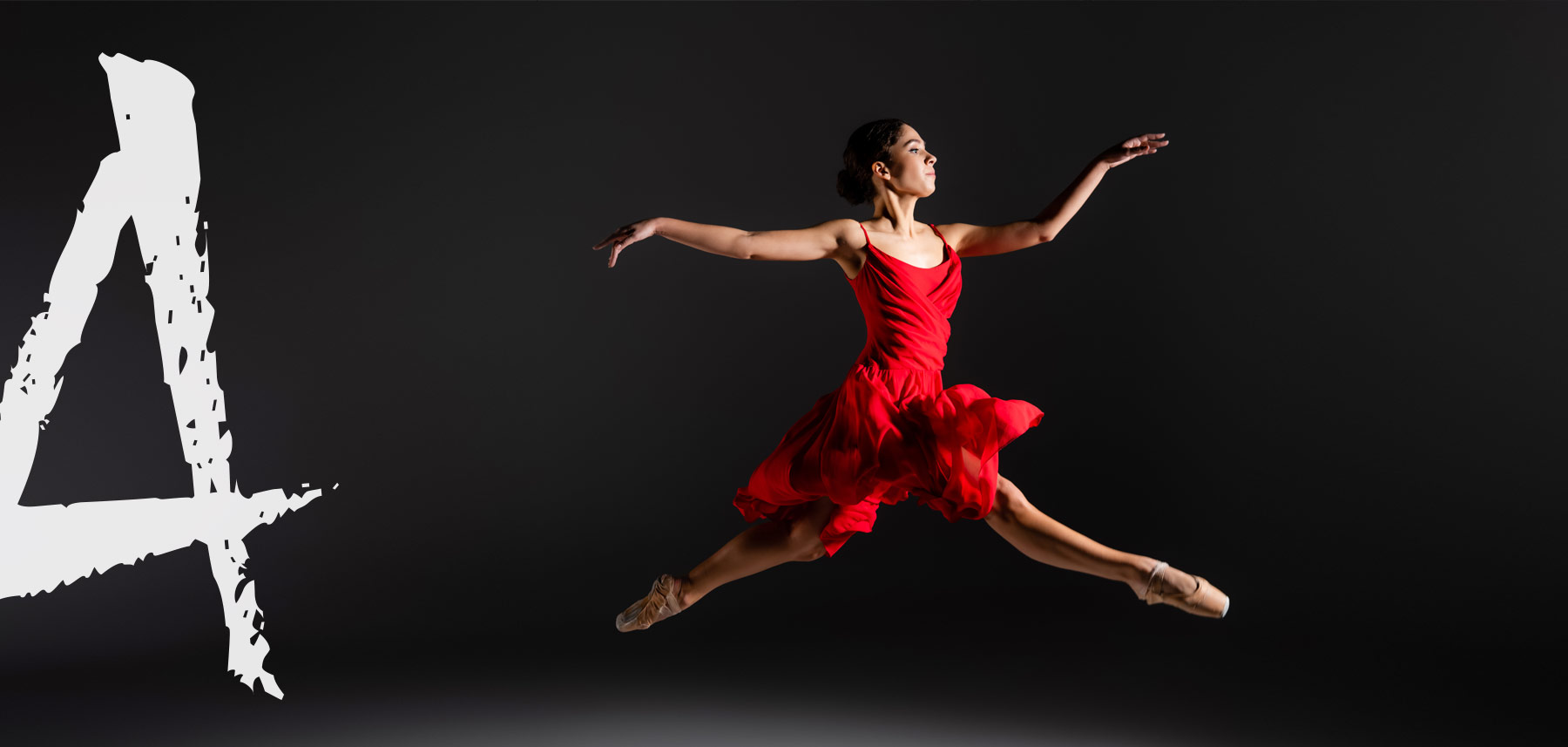Ballet dancer mid-leap in a red dress